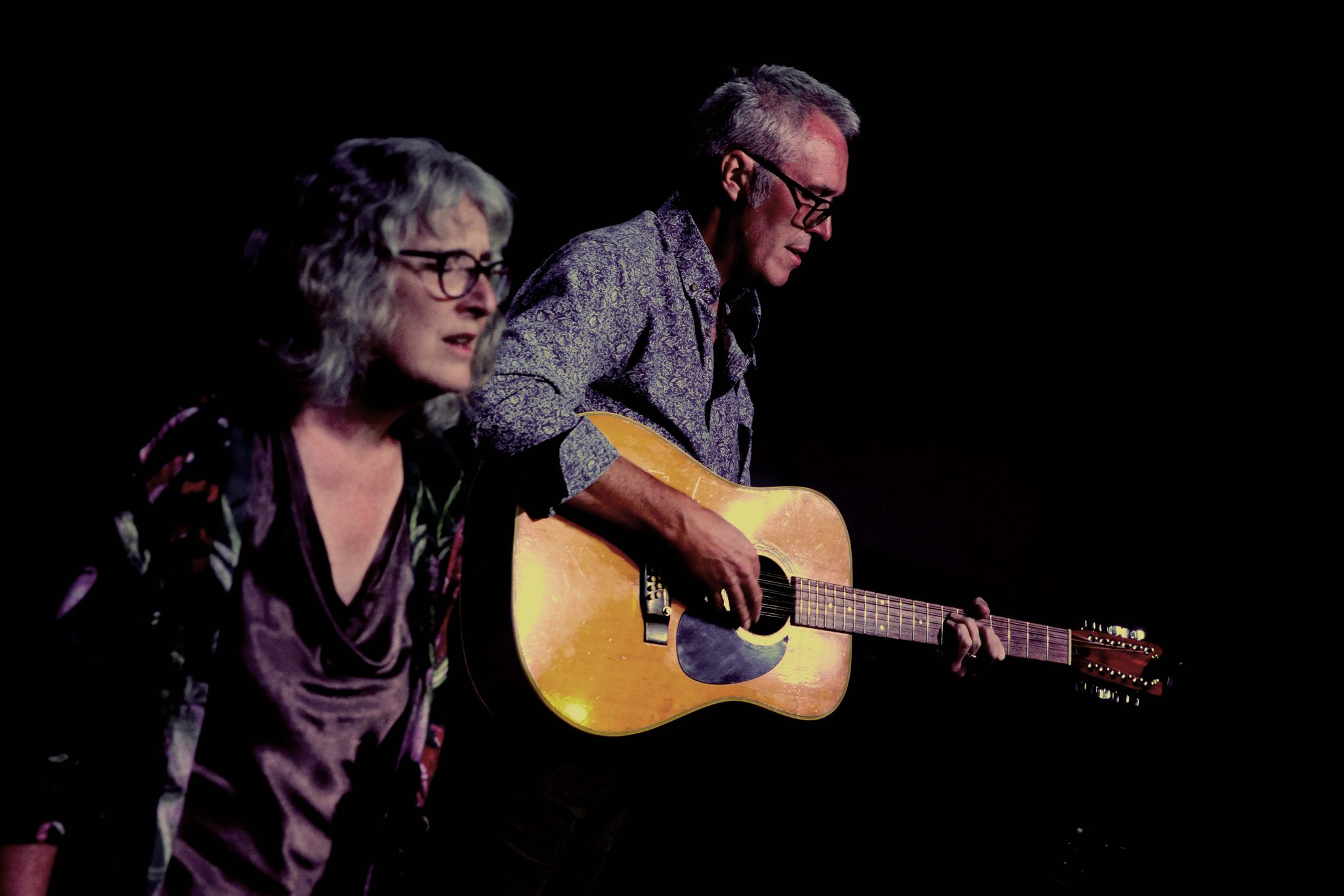 Man and woman singing, guitar